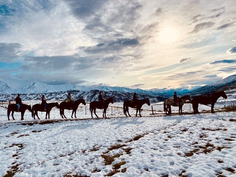 A group enjoying a guided horse trek through the snowy Cardrona Valley near Wanaka and Queenstown.